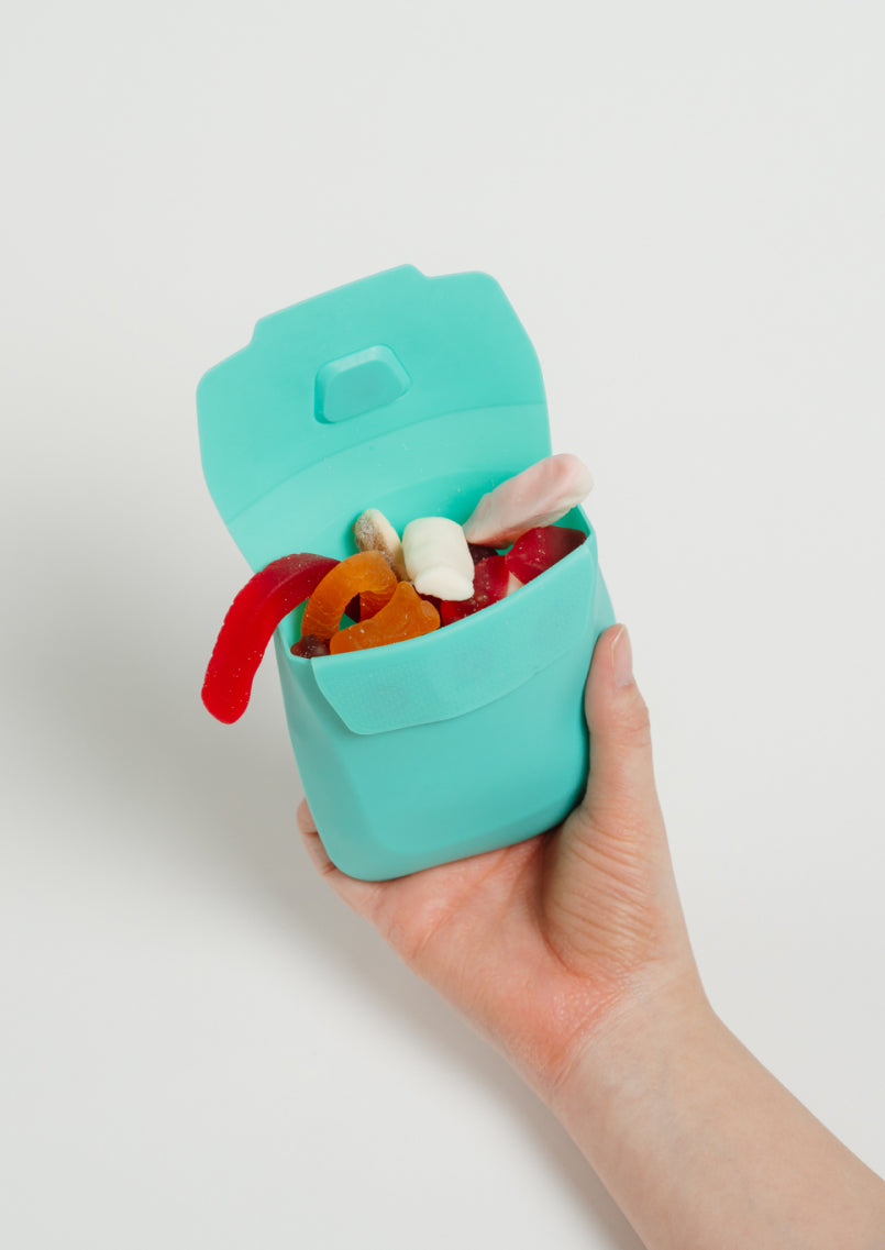 Snacket Aqua opened in hand with lollies