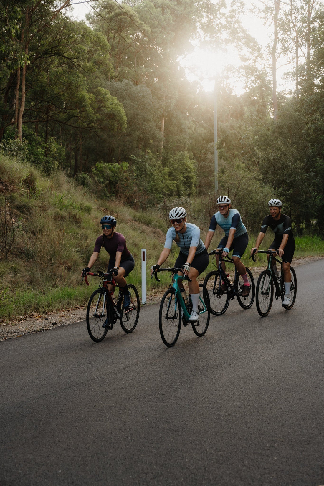 cyclists riding down a long road